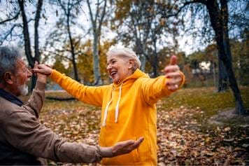 Sandia Hearing Aids Santa Fe - An older couple dancing in the park.