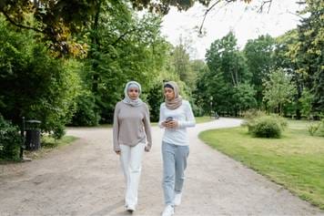 Sandia Hearing Aids Santa Fe - Two muslim women walking in the park.