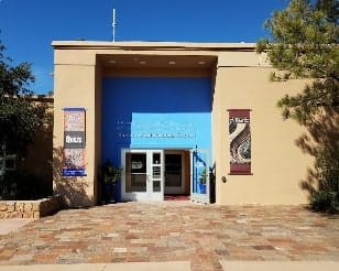 Sandia Hearing Aids Santa Fe - The entrance to a building with a blue door.