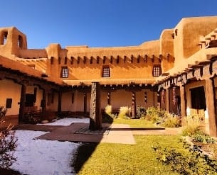 Sandia Hearing Aids Santa Fe - The courtyard of an adobe house.